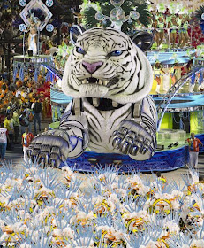 Flying tiger performers from the Inocentes de Belford Roxo samba school parade.