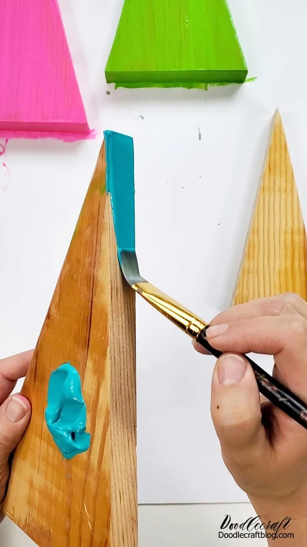 Work over a piece of unprinted scrap paper, or balance the triangles on something like a glass, so the edges can dry without sticking to the paper.