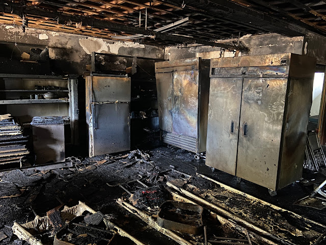 industrial kitchen after major fire has destroyed most of its contents and covered it with smoke and ash