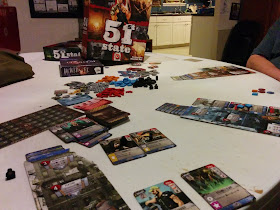 A game of 51st State in progress, with the game box visible in the background.