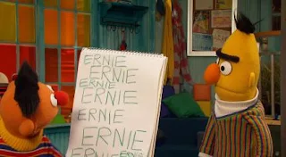 Ernie writes his name several times. Bert finds this annoying. Sesame Street Episode 5017, Magic Spell, season 50.