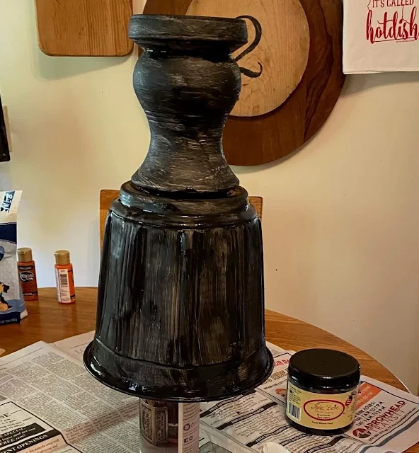 Photo of urn being painted black