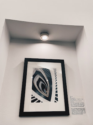 "Petal" by Jenny Lam, a photograph of the staircase inside the Museum of Contemporary Art Chicago shot on iPhone 5s in 2014, framed and hanging in the photography exhibition "Click" at The Art Center Highland Park in 2024