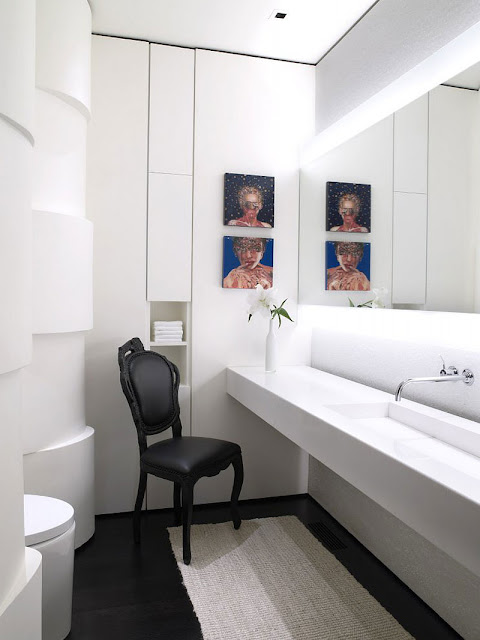 White bathroom and single black chair in the Aspen Residence by Stonefox