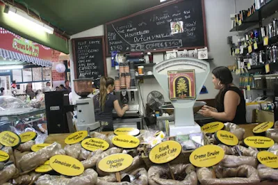 Various types of coffee beans in plastic packaging for sale in Fremantle Markets, Australia.