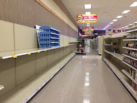 Empty shelves where toilet paper and other paper products should be