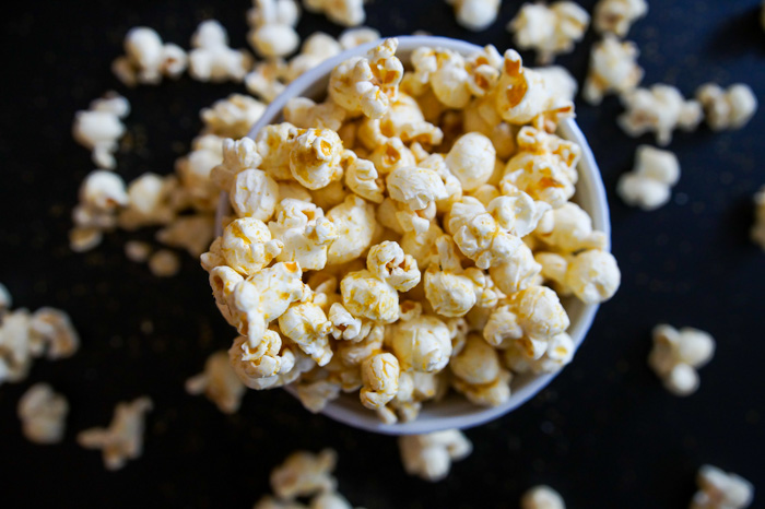 Trader Joe's Piquant Popcorn in bowl on black surface