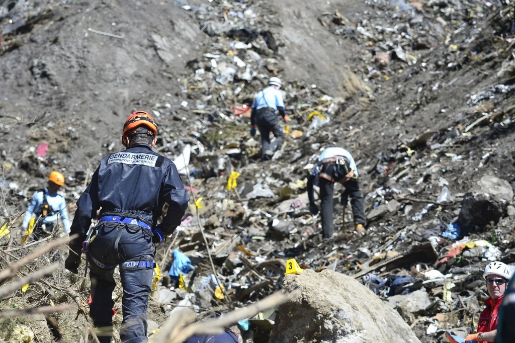 70 Of The Most Touching Photos Taken In 2015 - Rescue workers search the site of the Germanwings plane crash near the French Alps. The plane's co-pilot purposefully crashed the plane, killing all 150 on board.