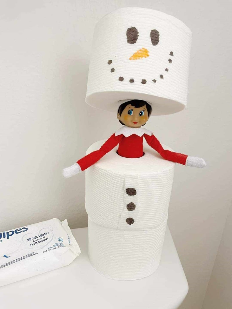 elf hiding in toilet paper snowman.