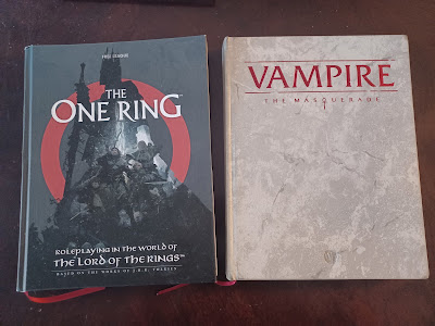 atwo hardcover game rulebooks-- The One Ring and Vampire: the Masquerade