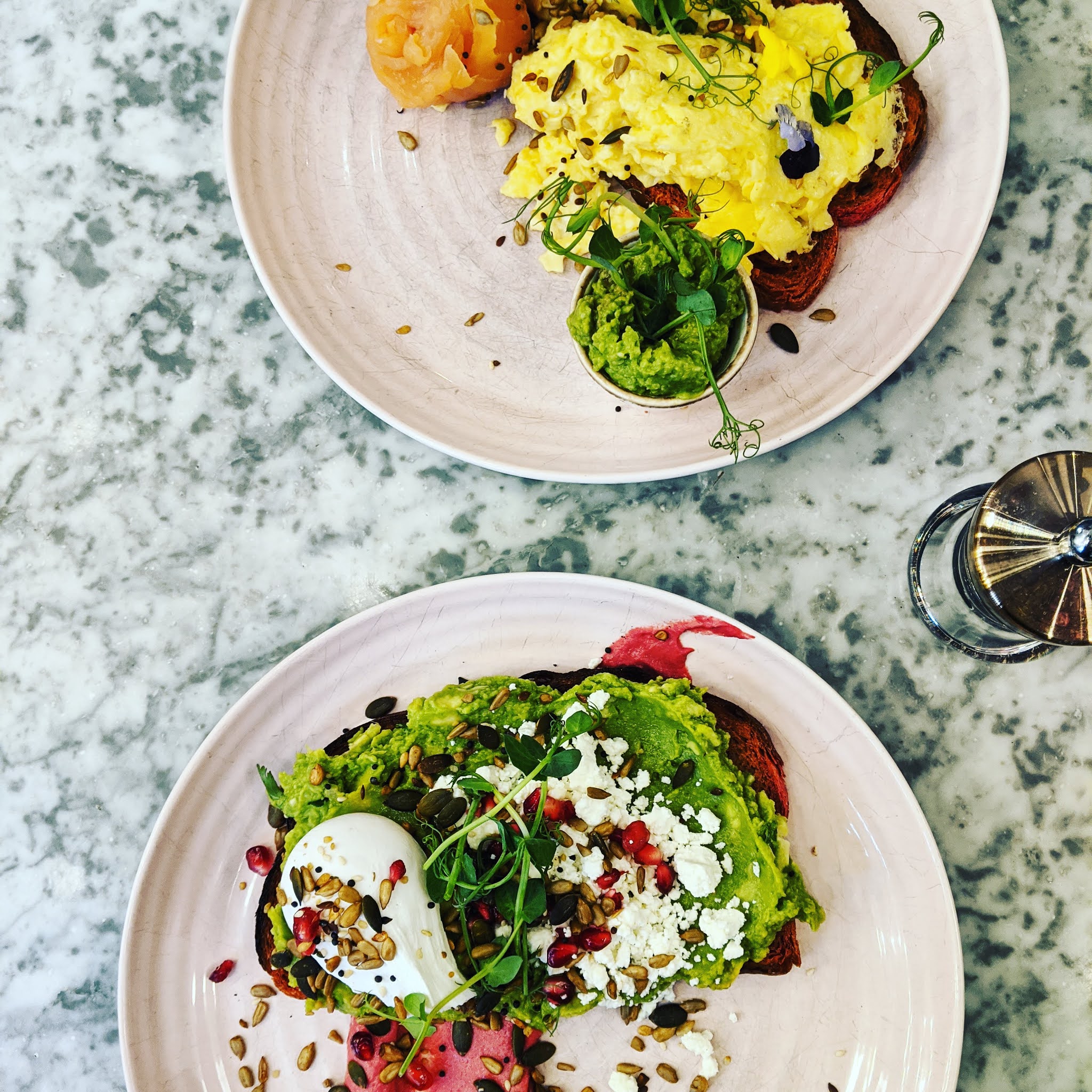 A plate of avocado on pink toast at Elan Café, one of the best avocado toast in London