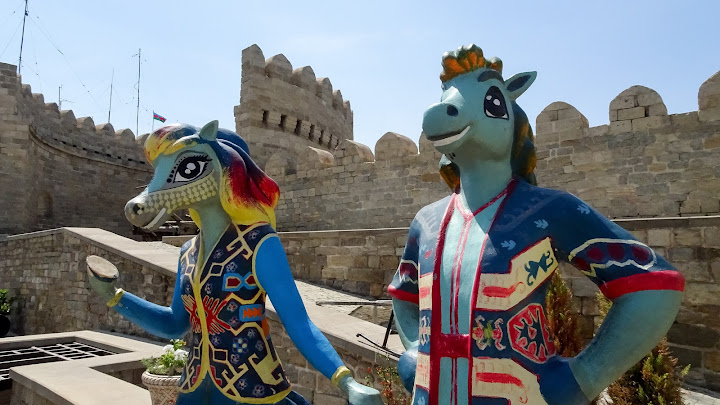 Horse woman and horse man in the old town of Baku