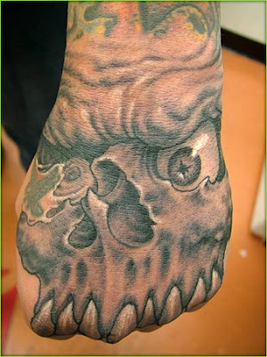 Red skull hand tattoo