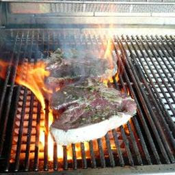 GRILLED PORTERHOUSE STEAK MARINATED IN GARLIC WITH PAPRIKA PARMESAN BUTTER