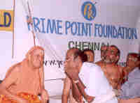 His Holiness Sri Kanchi Sankaracharya Swamigal listening to K. Srinivasan 