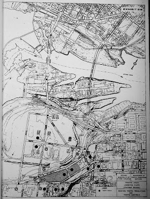 Black and white topographic map of LeBreton Flats and Chaudière area showing existing traffic regulations and traffic controls. The Portage Bridge and its Y intersection with Wellington Street is superimposed over the structures on Victoria Island and the previous cloverleaf-style offramp of Wellington Street at its connection to the Ottawa River Parkway.