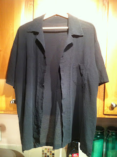 Black crinkle cotton bowling shirt on hangar.