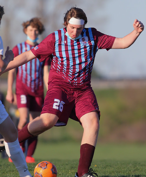 Cade Hausman kicks the ball