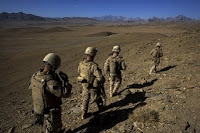US Marines climb through a mountain region suspected of being used by Taliban fighters while on patrol through an Afghan village in Farah Province, southern Afghanistan, September 29. By openly declaring their views on the Afghan war, US military leaders have placed President Barack Obama in a bind as he faces a fraught decision over the troubled US-led mission.