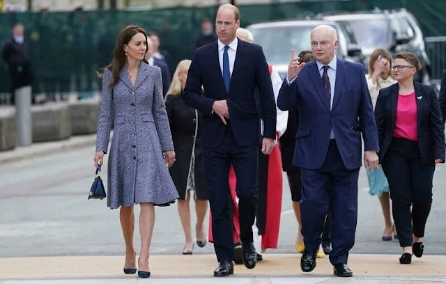 Kate Middleton wore a coat dress by Michael Kors. Vania Leles iconic Nile hoop earrings. Astley Clarke Stilla lapis pendant