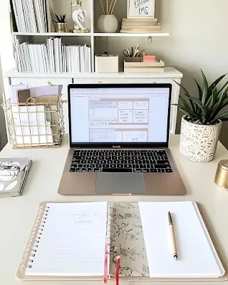 Organized desk with books, calendar, and planning materials representing editorial planning for book bloggers