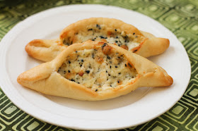 Food Lust People Love: A soft yeast dough filled with a blend of three salty cheeses, cilantro and nigella seeds, fatayer jebneh or Arabic cheese pies are baked till golden on the outside. The melted cheese on the inside is the perfect complement to the tender crust.
