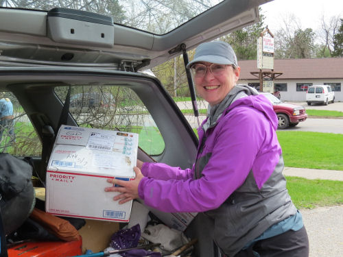 person getting box from post office