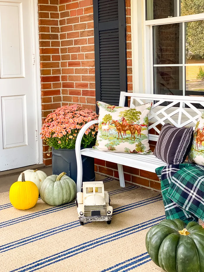 fall porch decor with bench and pumpkins