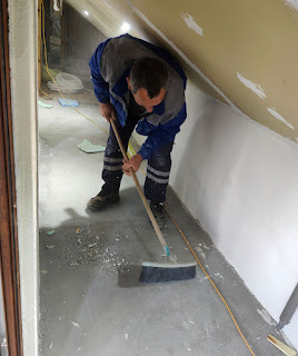 Bekir sweeping out the crawl space