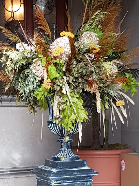 dried flowers and foilage in floor urn