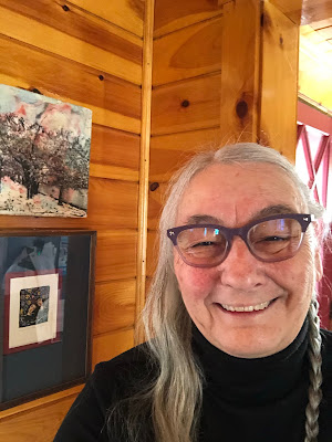 Selfie in Dining Room one side of hair braided the other waiting. Smiling.