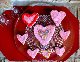 Raspberry Fudgy Brownie Hearts, Heart shaped raspberry infused brownies with a raspberry flavored frosting. Use a heart shaped cookie cutter or just cut in squares | Recipe developed by www.BakingInATornado.com | #recipe #chocolate #ValentinesDay