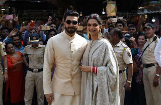 Indian Bollywood actors Ranveer Singh and Deepika Padukone pose for pictures as they visit the Siddhivinayak Temple in Mumbai