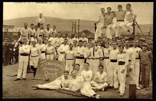 Black and white photo showing members of the Knockaloe Athletics Club in their white singlets and trousers