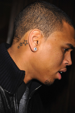 Three cute stars tattoo below a black man's ear