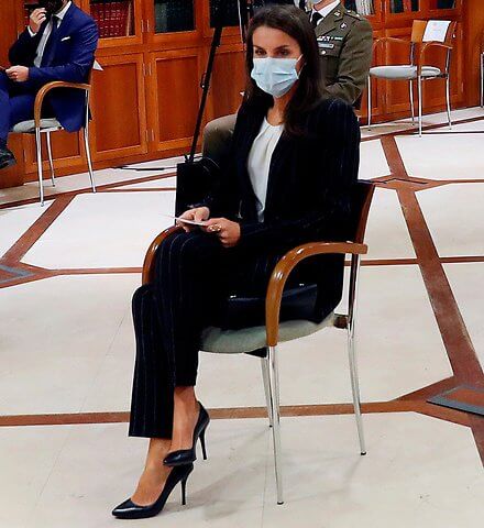Queen Letizia wore a new striped suit blazer from Hugo Boss. Letizia wore Hugo Boss Kocani striped suit. Magrit pumps, Carolina Herrera clutch