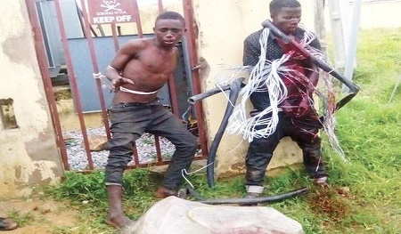 Omg! See 2 Suspected Cable Thieves Beaten & Tied to a Transformer in Abuja (Photo)