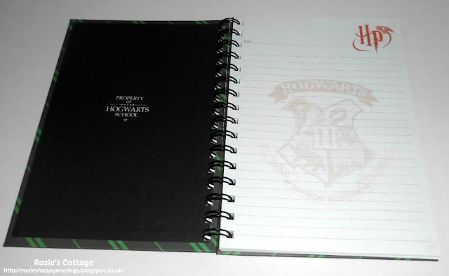 The inner cover of the hardback notebook announces that it is "property of Hogwarts School" while the pages are all printed with the Hogwarts crest "in shadow", the Harry Potter logo and a space to write the date are at the top of each page.  This would make an excellent diary or journal. 