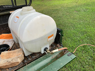 Water hose and tank on back of UTV