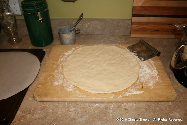 With a gentle touch, the dough is pressed and stretched to the desired size and thickness. 