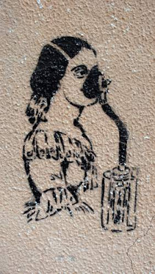 Graffiti image of an Italian woman with a gas mask on, found beside a canal in Venice, Italy.