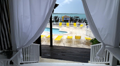 view looking out through massage booth curtains overlooking pool