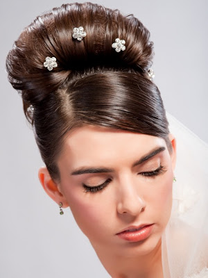 Two versions A sleek Audrey Hepburn bun with stick pin jewels