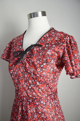 A dress on a dress form in a floral pattern