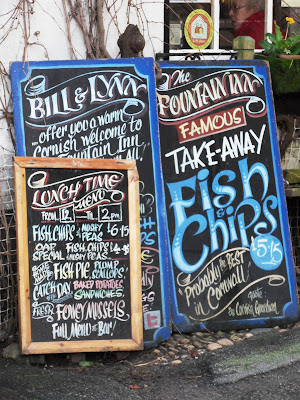 Traditional fish and chips signs in Mevagissey Cornwall