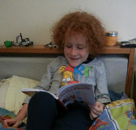 six year old reading funny children's book