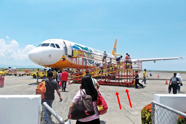 cebu pacific "air ramp" being used on the front door of a cebu pacific plane in tacloban