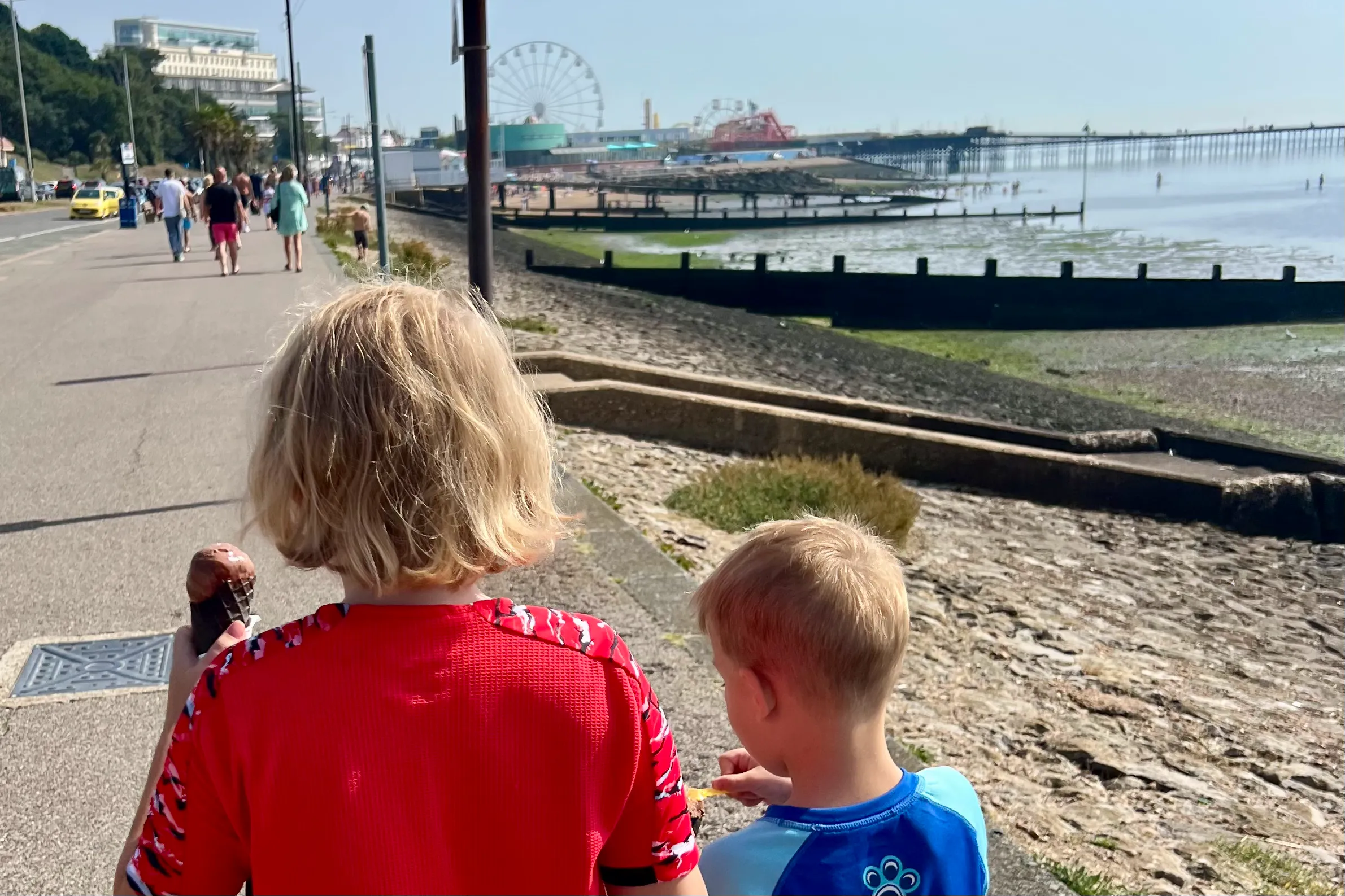 children walking along the beachfront in Southend, Essex, eating ice cream