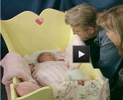 wooden baby cradle with head and footboard, plus scalloped edges 