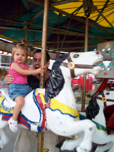 Daddy and one year old on the carousel